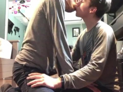 Cute young twink is sitting on the floor and kissing with gay friend